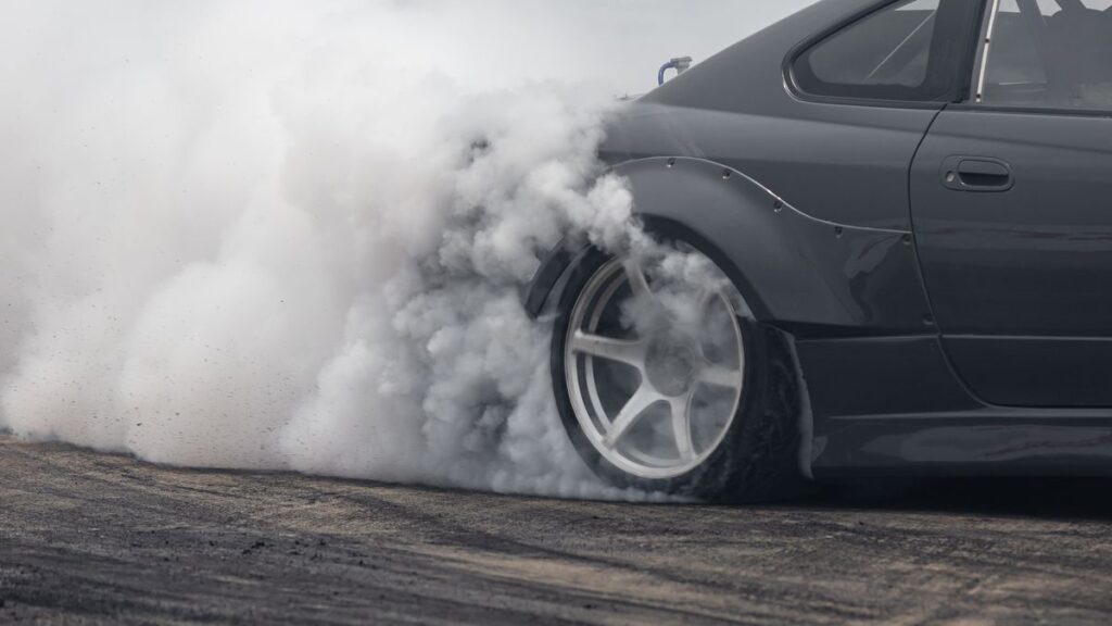 Car doing burnout during car takeover