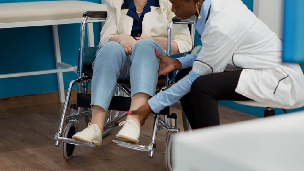 Doctor examining ankle after a car accident