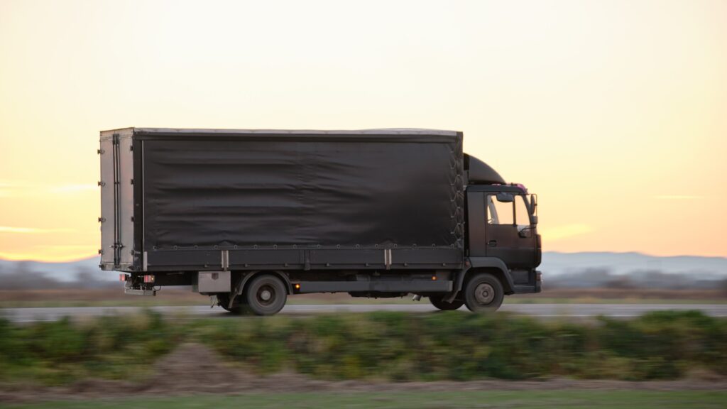 Cargo truck driving on highway at high speed