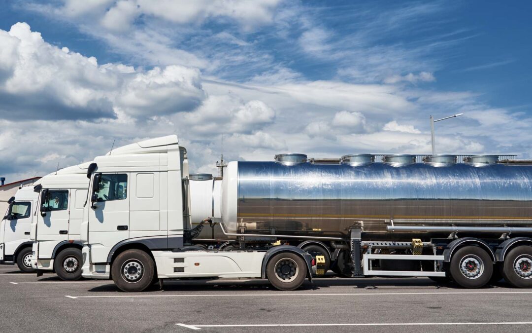 Tanker trucks sitting in a parking lot