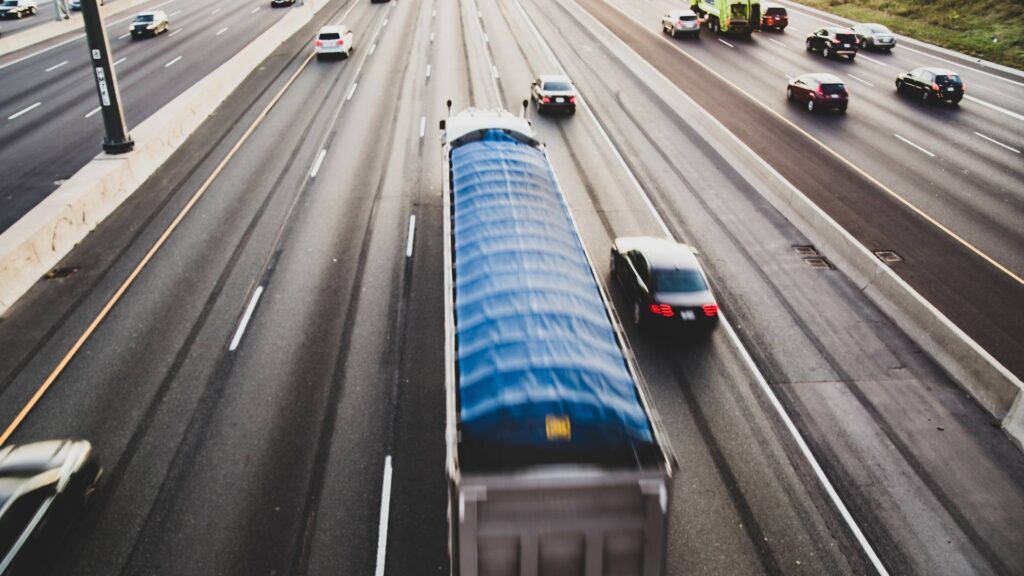 Truck flying by a car on highway interstate