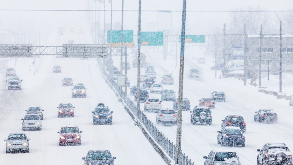 Cars driving on highway in major snowstorm