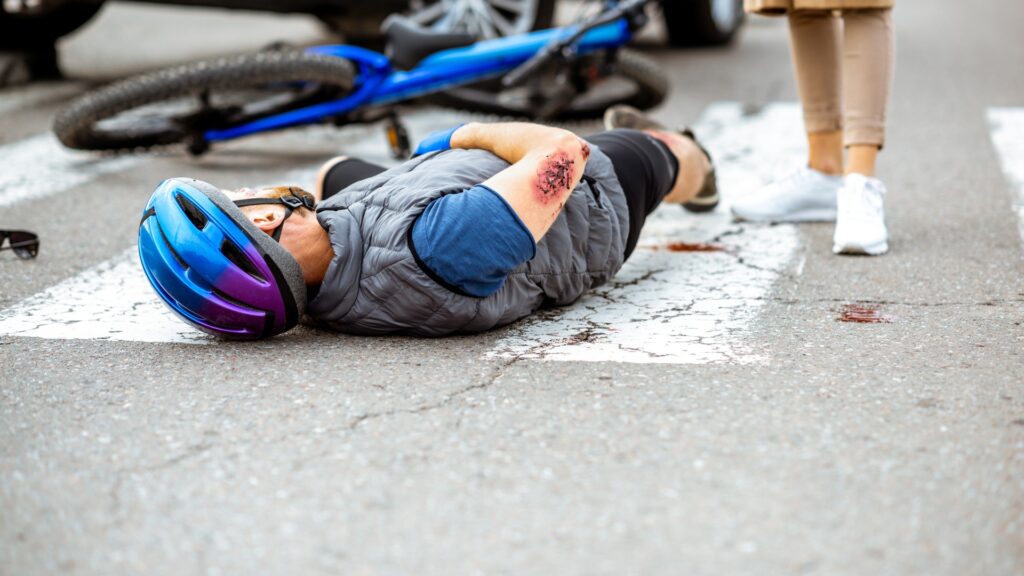 Injured bicycle rider hit by vehicle.