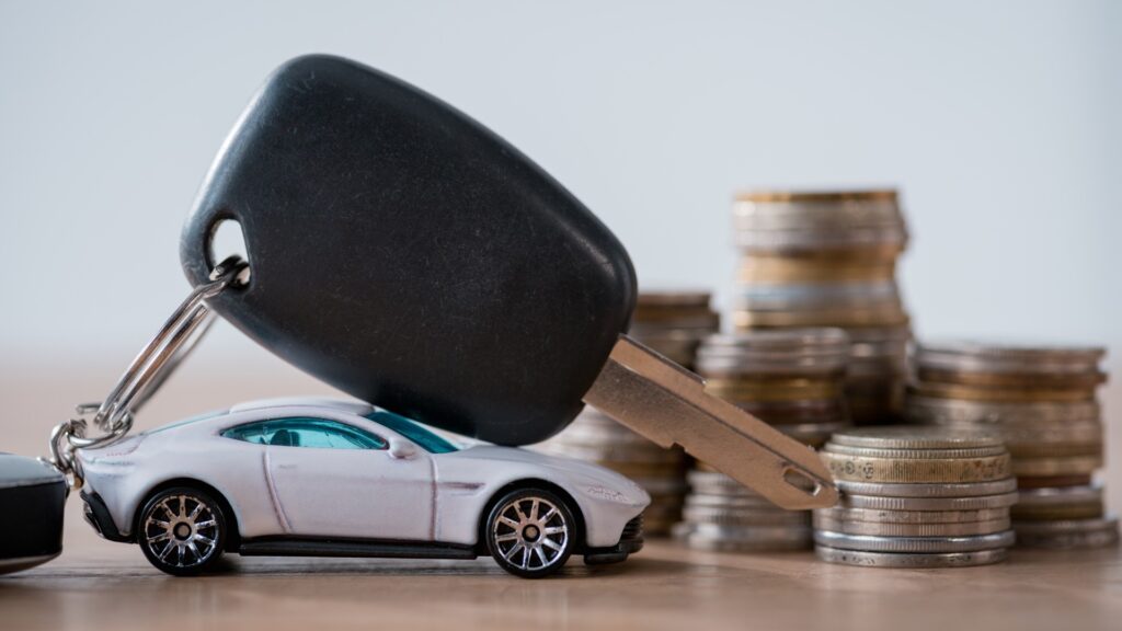 Car with key on top and money